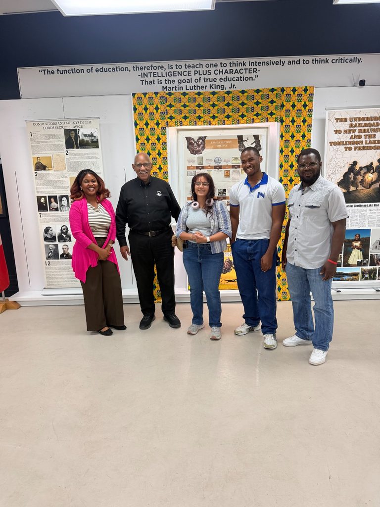 Group picture in front of an exhibit